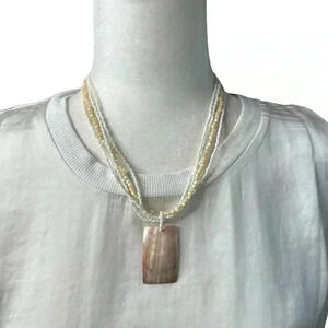 Abalone pendant on white and cream multi strand necklace 17”